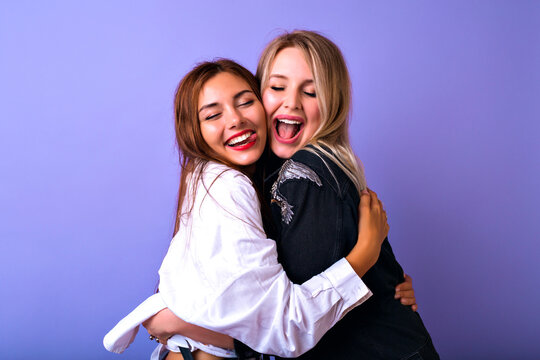 Young funny girls making selfie at studio making grimaces and going crazy