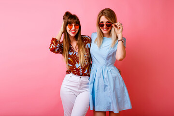 Two happy pretty sisters best friends hipster women having fun together