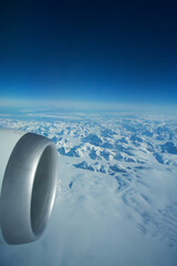 GREENLAND - 10 MAY 2018: View from the aircraft window of the engine of a Boeing 787 over the icebergs of Greenland