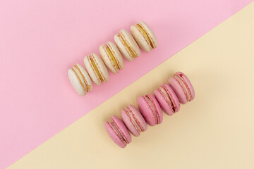 macarons cakes with vanilla and berry flavor on a background of pastel shades