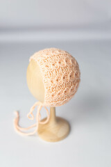 blue knitted peach hat on a mannequin head