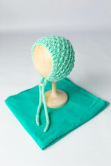 blue knitted hat and diaper for the baby. mint fabric jersey