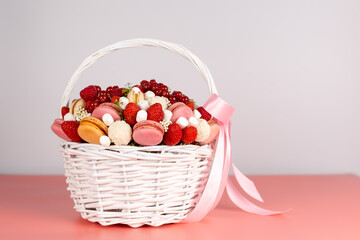 White wicker basket with berries and sweets
