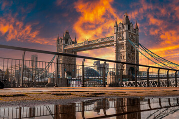 Iconic Tower Bridge view connecting London with Southwark over Thames River, UK. Beautiful view of the bridge during magical orange sunset over the city.