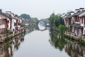 Fototapeta na wymiar Traditional house and stone bridge on the Grand Canal, Wuxi, Jiangsu Province, China