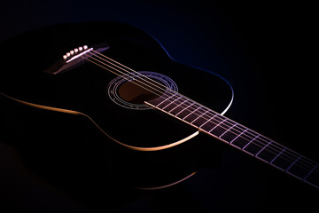 Obraz na płótnie Canvas black guitar against a dark background. guitar music low-key concept