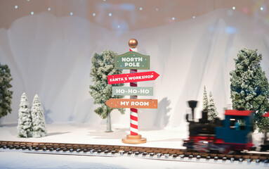 Beautiful Christmas decorations in a toy store window with these texts on it - north pole, santa...