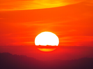 big sunset in sky clouds and mountain background