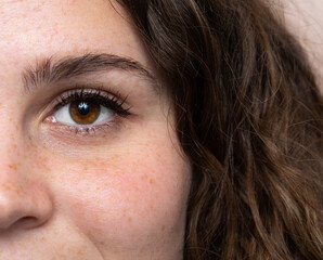 Caucasian woman face with brown eyes and curly hair