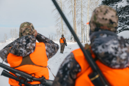 Hunters in a snowy landscape