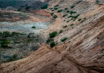 A sand pit with motorcycle tracks in the sand