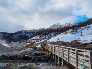  wooden bridge in the snow mountain background