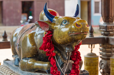 Cow sculpture at Hiranya Varna Mahavihar (Kwa Bahal), the Golden Temple, Kathmandu, Nepal - obrazy, fototapety, plakaty