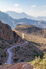 Middle East, Arabian Peninsula, Oman, Al Batinah South, Rustaq. A road passing through the desert mountains of Oman.