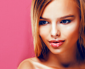 Fototapeta premium young pretty blonde real woman with hairstyle close up and makeup on pink background smiling