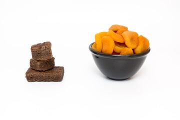 Healthy dried apricot fruit and chocolate brownie on white background for lifestyle choice concept