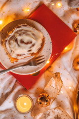 Christmas flatlay with cinnamon rolls and candles