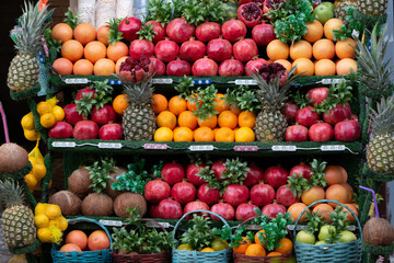 Very colorful fruits. Orange, pomegranate, pineapple, coconut, kiwi, mandarin in market