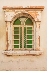 Middle East, Arabian Peninsula, Al Batinah South. Green shuttered window on a building in Oman.