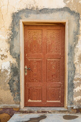 Middle East, Arabian Peninsula, Al Batinah South. Carved wooden door on a building in Oman.