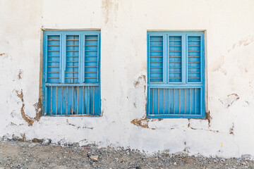 Middle East, Arabian Peninsula, Oman, Al Batinah South. Blue shuttered and barred windows.