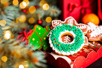 Christmas composition. A Christmas tree decorated with toys and a garland and gingerbreads.