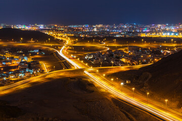 Fototapeta na wymiar Middle East, Arabian Peninsula, Oman, Muscat, Bawshar. Night view of roads in Muscat.