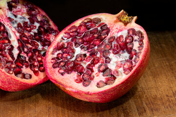Cut pomegranate on an antique cutting board