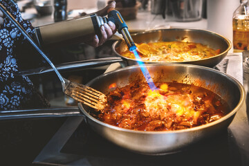 gas burner is in the hands of the boss. Cooking liver dishes in white wine for a warm salad...