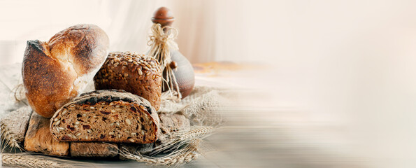 Assorted bread products on a wooden table. variety of wheat and rye bread are presented on a wooden relief background. Copy space