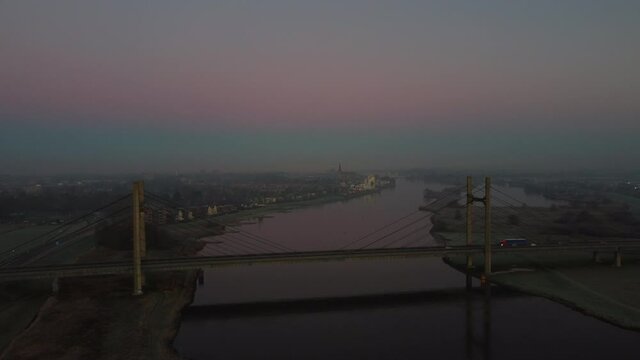 Aaerial view over the Molenbrug over the river Ijssel during sunrise during a cold winter morning in Overijssel, Netherlands.