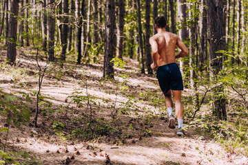 Male athlete runner in intense sprint during outdoor crossfit workout