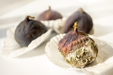 Mold on ripe purple figs close - up . Selective focus. Mold spores during fruit transportation....