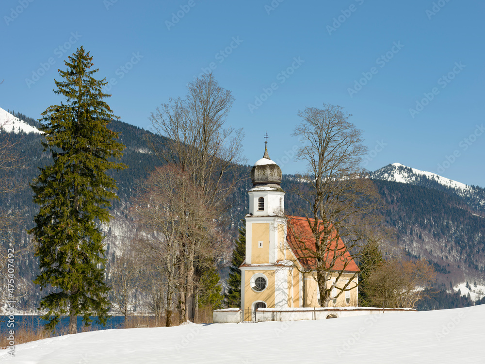 Sticker Church Sankt Margareth at Zwergern Spitz. Lake Walchensee near village Einsiedl in the snowy Bavarian Alps. Germany, Bavaria