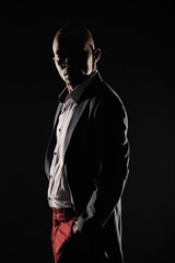 Posing with his hands in the pockets