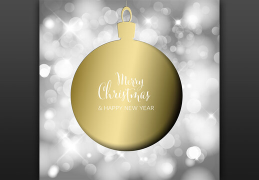 Christmas Card on Golden Bauble Decoration Silhouette and Blurred Background