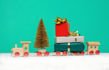 wooden children's train toy with Christmas presents gift box, Happy Holiday card, Merry Christmas and happy New Year celebration