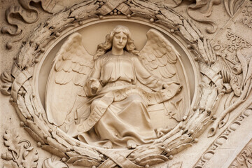 Fototapeta premium Hungary, Budapest. Architectural detail, relief of angel with banner reading 'Gloria In Excelsis Deo', 'Glory to God in the Highest'.
