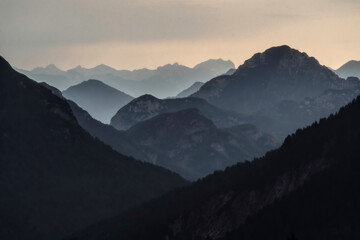 Europe, Italy, Friuli Venezia Giulia. Foggy Monte Lussari mountain at sunset.