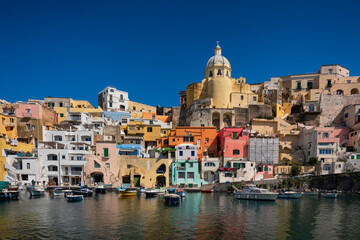 Fototapeta na wymiar Europe, Italy, Procida. City houses and boats in Marina Corricella.