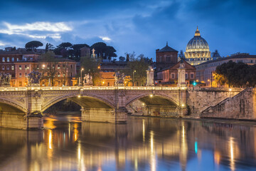 Europe, Italy, Rome. Dome of Sistine Chapel with Tiber River and bridge lit at sunset.