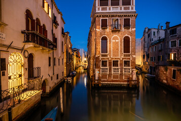 Obraz na płótnie Canvas Europe, Italy, Venice. Two converging canals and buildings at sunset.