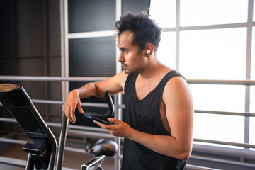 person using his phone in the gym