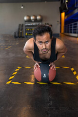 Portrait of a fitness person doing push ups in gym