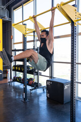 person  doing pull ups at the gym 