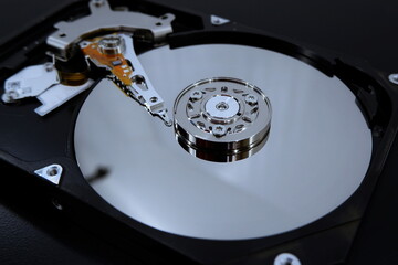 Mirror drive hdd write read head, 2.5 inch computer hard drive without cover. Data storage concept.