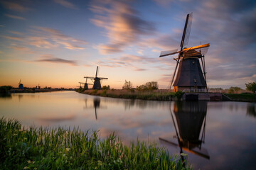 Fototapeta na wymiar Europe, The Netherlands. Kinderdijk windmills at sunset.