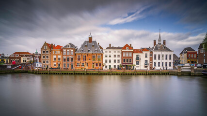 Fototapeta na wymiar Europe, The Netherlands, Maassluis. Row of buildings on ocean pier.