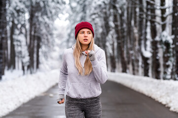 A young woman running during a snowy day.