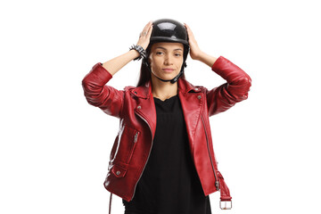 Female biker putting on a helmet